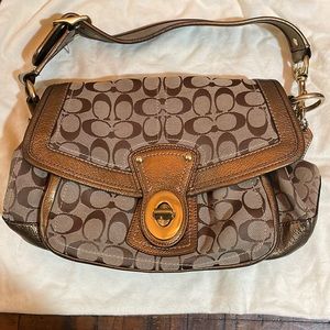 Coach legacy brown and gold monogram shoulder bag. Multicolored striped inside